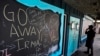 FILE - A chalkboard is decorated with messages regarding the approaching Hurricane Irma as a person reads a sign stating a restaurant is closed in Flagler Beach, Fla., Sept. 8, 2017. 