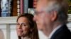Supreme Court nominee Judge Amy Coney Barrett looks over to Senate Majority Leader Mitch McConnell of Kentucky as they meet with on Capitol Hill in Washington, Sept. 29, 2020. 