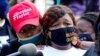 Tamika Palmer, right, the mother of Breonna Taylor, listens to a news conference, Sept. 25, 2020, in Louisville, Ky. 