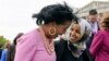 FILE - U.S. Reps. Jahana Hayes, D-CT., left, and IIhan Omar, D-Minn., right, walk together after taking a group photo with other members of the freshman class of Congress on Capitol Hill in Washington. 