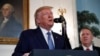 President Donald Trump, accompanied by Secretary of State Mike Pompeo, speaks in the Diplomatic Room of the White House in Washington, Oct. 23, 2019. 
