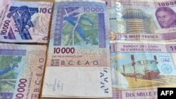 FILE - CFA franc banknotes, in circulation in Cameroon, are seen in a April 9, 2016, photo. Fourteen senior state officials in Cameroon have been arrested and detained within the past two weeks on charges linked to corruption.