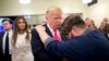 FILE - Pastor Joshua Nink, right, prays for Republican presidential candidate Donald Trump, after a Sunday service at First Christian Church, in Council Bluffs, Iowa, Jan. 31, 2016.