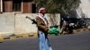 An armed Houthi Shi'ite Yemeni stands guard outside the Republican Palace in Sana'a, Feb. 16, 2015.