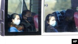  People wear masks as they ride on a public bus in Pyongyang, North Korea, Feb. 26, 2020.
