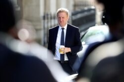 FILE - Britain's Secretary of State for Digital, Culture, Media and Sport Oliver Dowden arrives for a Cabinet meeting, at Downing Street in London, Britain, July 21, 2020.