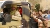 Tuareg fighters from the Movement for the Liberation of Azawad sit in their vehicle, in a market in Timbuktu, Mali, April 14, 2012.