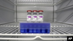  In this Monday, March 22, 2021 file photo, AstraZeneca and Biontech coronavirus vaccine in a fridge at the vaccine center in Ebersberg near Munich, Germany. 