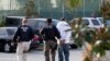 Immigration and Customs Enforcement agents take a suspect into custody as part of a nationwide immigration sweep in Chula Vista, California, March 30, 2012.
