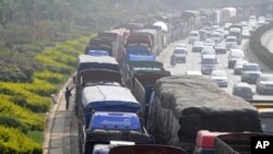 Vehicles line up for diesel near a gas station in Kunming, Yunnan province, China. Controlling soot from trucks, cars, planes, boats and wood and dung fires can have an immediate impact on climate change.
