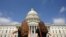 Women gaze at the dome of the US Capitol, days after the removal of security fencing which was placed around the complex after the Jan. 6 attack, in Washington, July 12, 2021. 
