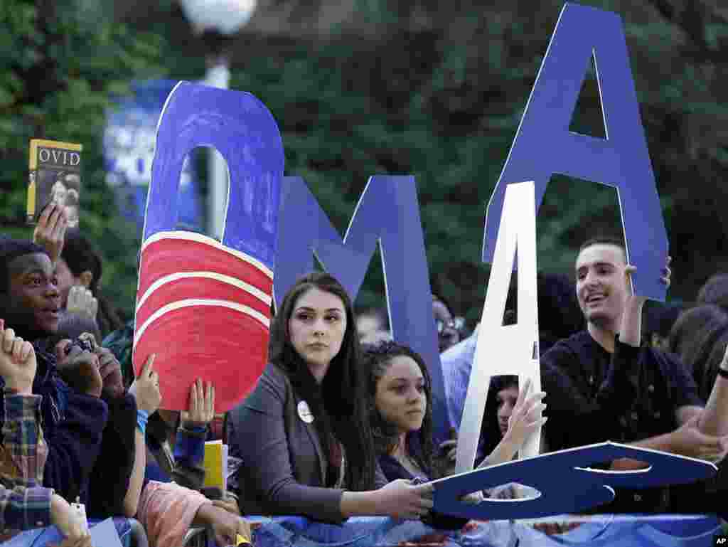 Students show their support for President Barack Obama as they gather around a television network set on the campus of Hofstra University in Hempstead, New York, site of the presidential debate, October. 16, 2012.