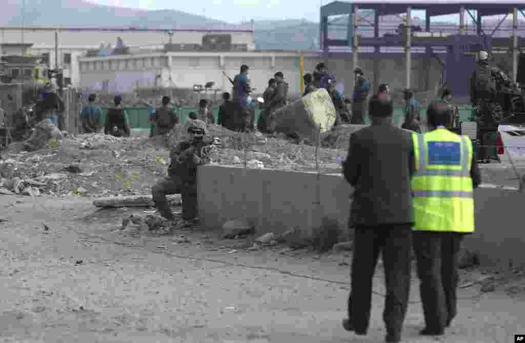 A U.S. soldier takes his position near the site of a suicide attack in Kabul, Afghanistan, Oct. 13, 2014.