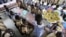 FILE - Students wait to eat at a school canteen in N'zikro, Aboisso, Ivory Coast.