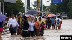 Stranded tourists salvaged belongings from submerged cars in the Mexican beach resort of Acapulco which had become a floodplain on Tuesday after some of the worst storm damage in decades killed more than 50 people across the country, Sept. 17, 2013. 