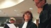 Prosecutor, Justice Louise Arbour, centre, talks to Mark Harmon, right, Senior Trial Attorney, shortly before the beginning of the hearing at the International Criminal Tribunal for former Jugoslavia in The Hague, file photo. 
