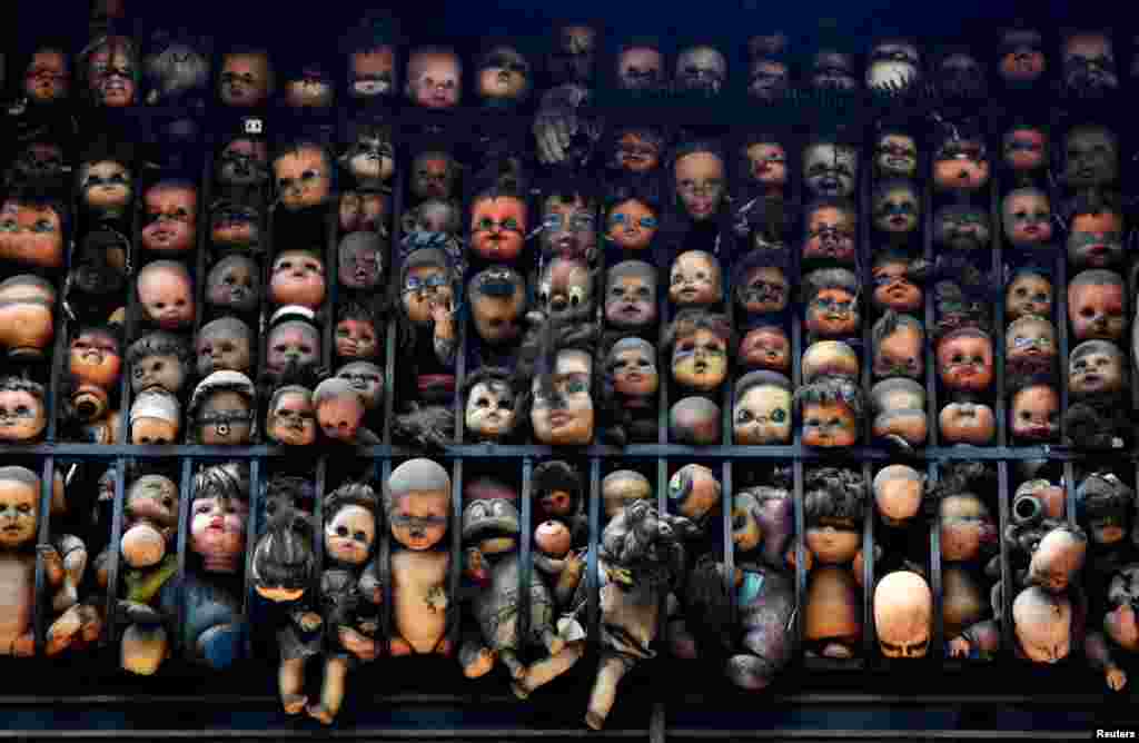 Dolls are seen on the balcony of artist and collector Etanis Gonzalez in Caracas, Venezuela.
