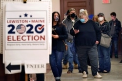 FILE - Residents wait to cast their absentee ballots during early voting, in Lewiston, Maine, Oct. 30, 2020.