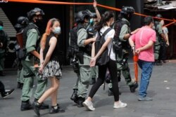 Police detain protesters after a protest in Causeway Bay before the annual handover march in Hong Kong, July. 1, 2020.