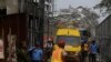 Rescue workers gather around an ambulance with a survivor found in the rubble of the collapsed 21-story apartment building under construction in Lagos, Nigeria, Nov. 2, 2021.