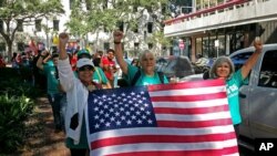 FILE - Demonstrators march outside federal court in New Orleans, Sept. 22, 2017, with immigrants and their advocates chanting and beating drums to protest immigration laws.