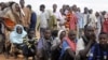 Newly arrived Somali refugees line up to wait for the reception center to open at Ifo settlement at Kenya's Dadaab Refugee Camp, situated northeast of the capital Nairobi near the Somali border, September 1, 2011. 