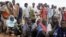Newly arrived Somali refugees line up to wait for the reception center to open at Ifo settlement at Kenya's Dadaab Refugee Camp, situated northeast of the capital Nairobi near the Somali border, September 1, 2011. 