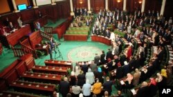New Tunisian National Assembly parliement members stand during the first session of the chamber, Wednesday Nov.13, 2019 in Tunis. Tunisia's new parliament opened with a session to elect a speaker after last month's election. 
