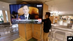 University of Utah student Suyog Shrestha turns on a TV in the student union on the campus in Salt Lake City as Rep. Adam Schiff, the Democratic chairman of the House Intelligence Committee, makes his opening remarks, Nov. 13, 2019. 