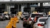 Cars line up to cross into the U.S. at the Mexico-U.S. San Ysidro border crossing, in Tijuana, Mexico, March 19, 2020.