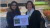 Women’s rights activists Maryam Qashqaei Shojaei and Gigi Alford hold a petition outside FIFA’s Zurich headquarters, Nov. 8, 2018. The petition calls for an end to Iran’s decades-old ban on Iranian women buying stadium tickets for men’s sporting events.
