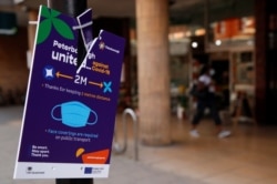 A social distancing sign is pictured in Peterborough, Britain, Aug. 3, 2020.