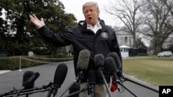 President Donald Trump talks with reporters outside the White House before traveling to Alabama to visit areas affected by the deadly tornadoes, March 8, 2019, in Washington.