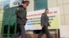 Police officers walk outside a polling station in Dushanbe November 1, 2013. Tajikistan's President Imomali Rakhmon is expected to win a new seven-year term in an election on Nov. 6, extending his rule in the former Soviet republic in Central Asia to near