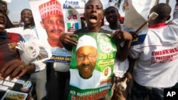 Supporters of former military leader, Muhammadu Buhari, and presidential aspirant, chant slogans during the All Progressive Congress party convention in Lagos, Nigeria,Wednesday, Dec. 10, 2014. 