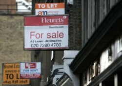FILE - Property advertisements are seen in central London.