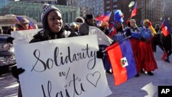 FILE - Haitian activists and immigrants protest on City Hall Plaza in Boston, Jan. 26, 2018.