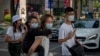Members of a Chinese family wearing face masks walk in Bangkok, Thailand, Jan. 29, 2020. The Tourism Council of Thailand estimates the coronavirus outbreak will cost 50 billion bhat (U.S. $1,613,892) in lost tourism income for the Thai economy.