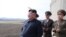 FILE - North Korean leader Kim Jong Un, accompanied by military officials, observes a Korean People's Air Force training flight at undisclosed location in this April 16, 2019, photo released April 17, 2019 by North Korea's Central News Agency (KCNA).