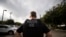 FILE - A U.S. Immigration and Customs Enforcement officer looks on during an operation in Escondido, Calif., July 8, 2019.
