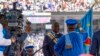 A Constitutional Court judge hands the national flag to President Felix Tshisekedi after taking the oath of office, on the day of his ceremony at the Stade des Martyrs in Kinshasa, on January 20, 2024.