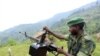 A M23 rebel fighter prepares his machine gun at their defense position in Karambi, eastern Democratic Republic of Congo (DRC) in north Kivu province, near the border with Uganda, July 12, 2012. 