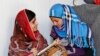 Pakistani teenage activist Malala Yousafzai (L), who was shot in the head by the Taliban for campaigning for girls&#39; education, talks to Syrian refugee Mazoon Rakan, 16, about Mazoon&#39;s experience in the camp during her visit to the Zaatri refugee camp, in 
