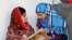 Pakistani teenage activist Malala Yousafzai (L), who was shot in the head by the Taliban for campaigning for girls&#39; education, talks to Syrian refugee Mazoon Rakan, 16, about Mazoon&#39;s experience in the camp during her visit to the Zaatri refugee camp, in 