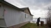 FILE - Tim Betts removes a horseshoe pit that he recently built at his family's beachfront home that is sitting off of its foundation in Washaway Beach, Washington.