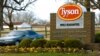 FILE - A car passes in front of a Tyson Foods Inc. sign at Tyson headquarters in Springdale, Ark., Jan. 29, 2006.