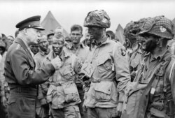 General Dwight D. Eisenhower encouraging paratroopers on June 5, 1944, before they board their planes to participate in the first assault of the Normandy invasion during World War II. (Courtesy - Eisenhower Library and Museum)