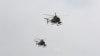 FILE - U.S.-made MD-530 helicopters, like the ones used by the Afghan Air Force, fly over Kabul, Afghanistan, Feb. 11, 2016. 