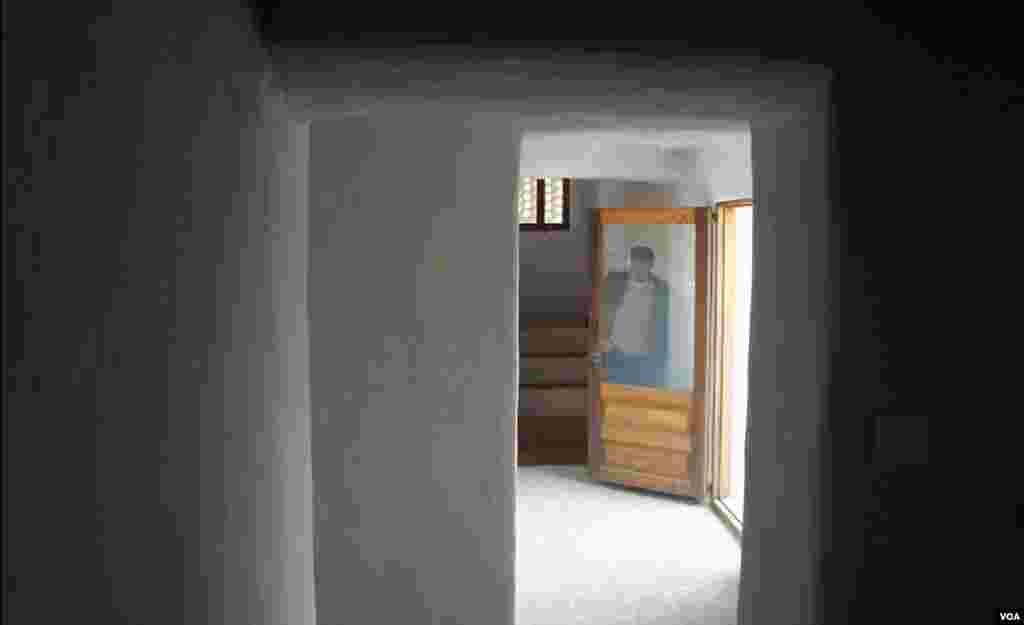 Architect Abdullah al Hadrami, behind a door leading to the porch. (E. Arrott/VOA)