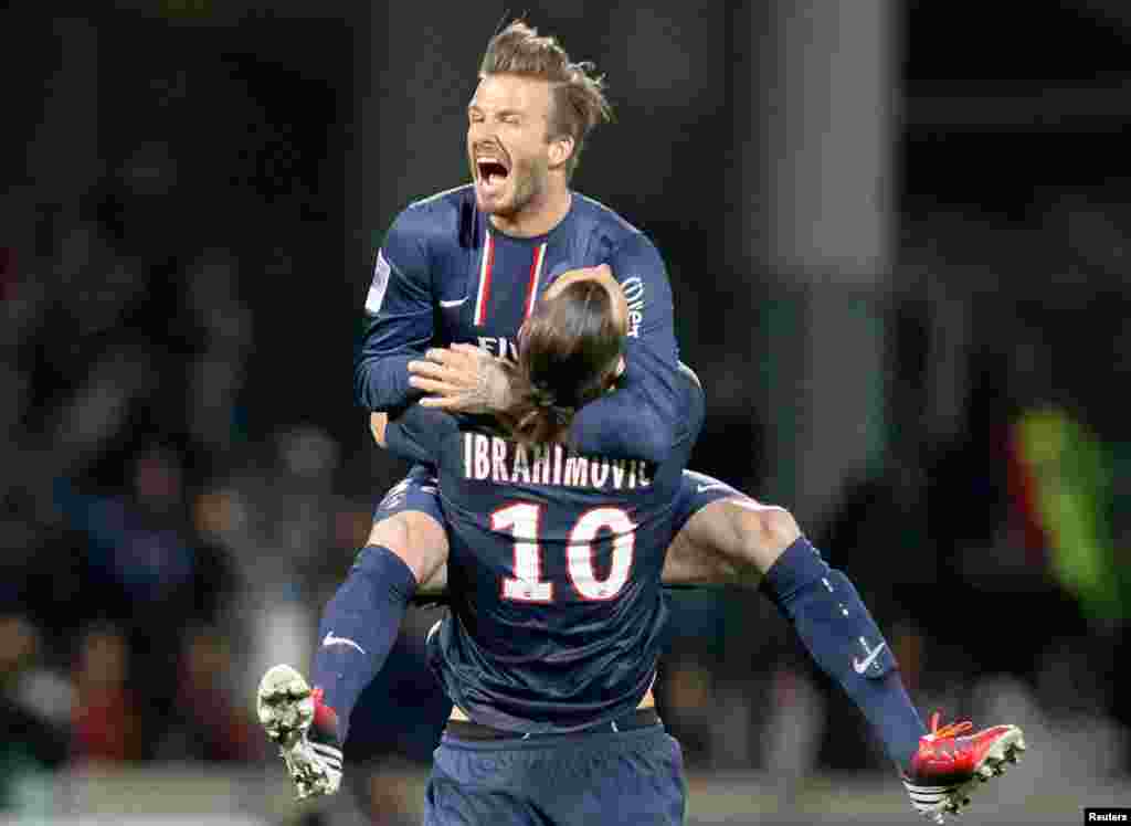 Paris Saint-Germain's Zlatan Ibrahimovic and David Beckham celebrate at the end of their team's French Ligue 1 soccer match against Olympique Lyon, May 12, 2013.
